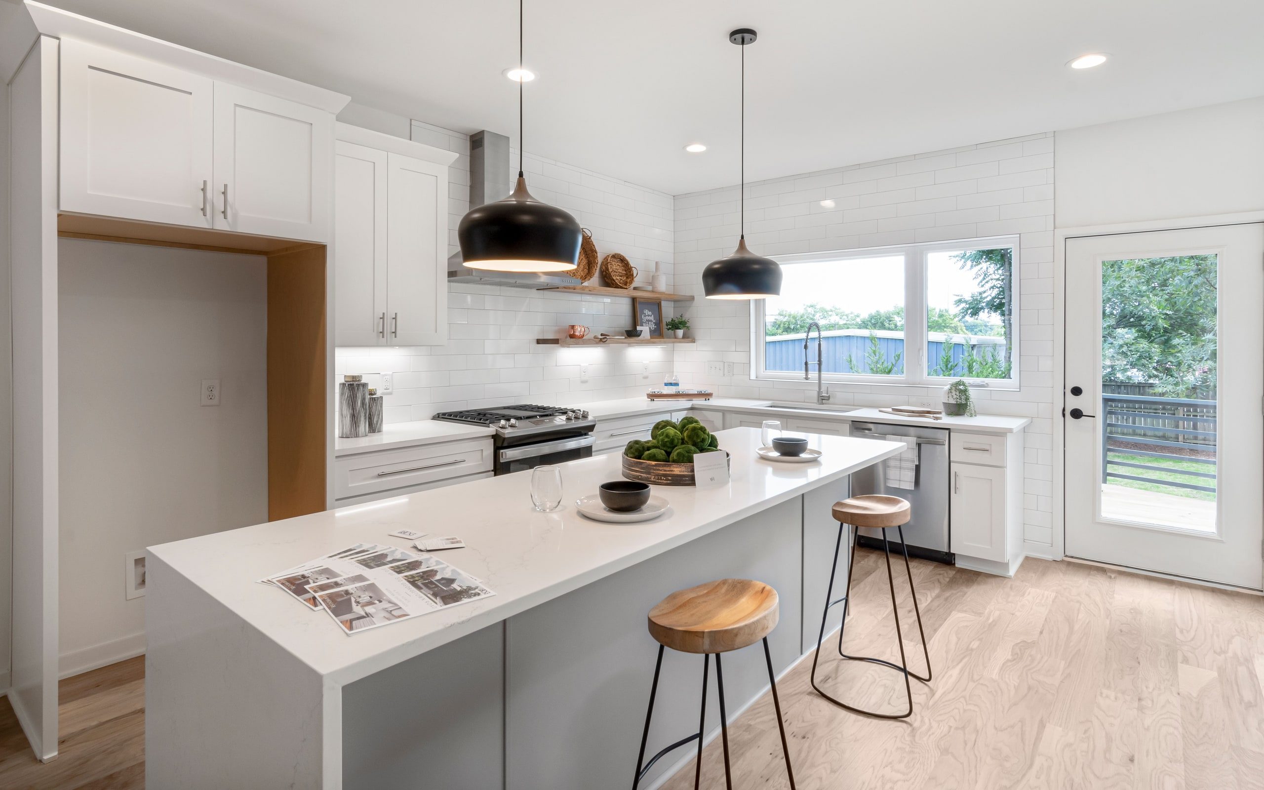 A bright kitchen with white cabinetry and an island