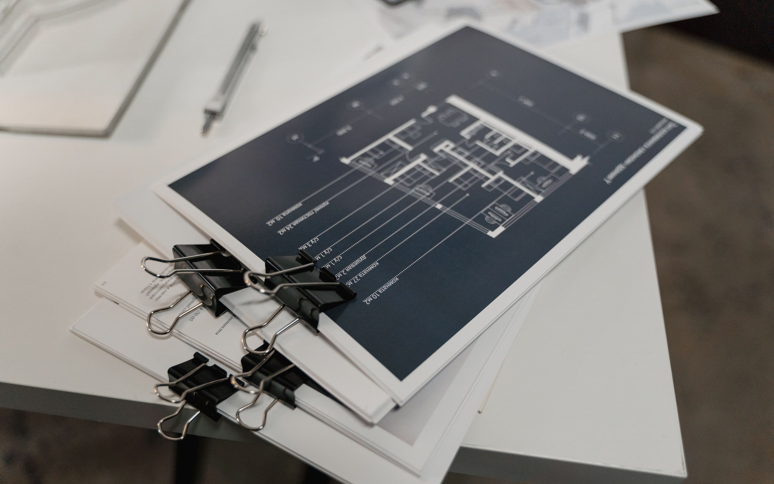 Bound sets of floor plans stacked on a table