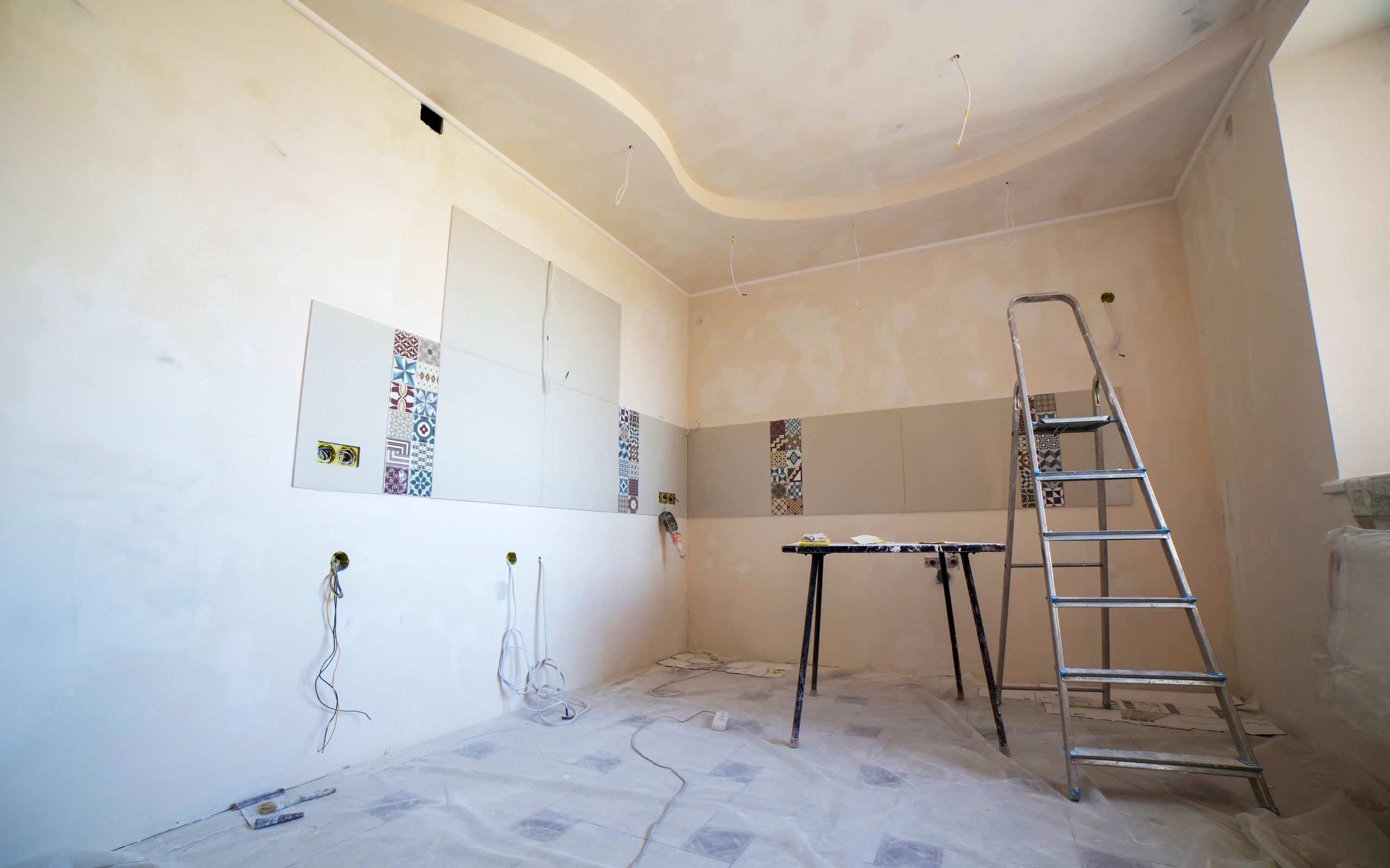 A room mid-renovation, floor protected and finishes going up